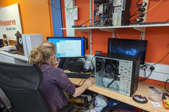 IT specialist installing and configuring computer system for client